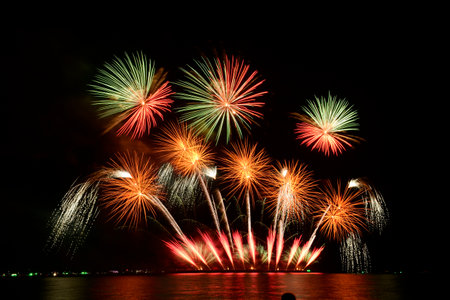 Firework celebration from the sea shore. Colorful fireworks celebration and the night sky background. International fireworks festival at Pattaya Thailand.の写真素材