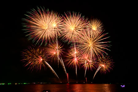 Firework celebration from the sea shore. Colorful fireworks celebration and the night sky background. International fireworks festival at Pattaya Thailand.の写真素材