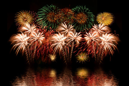 Colorful fireworks celebration and the night sky background with reflection on the water..の写真素材
