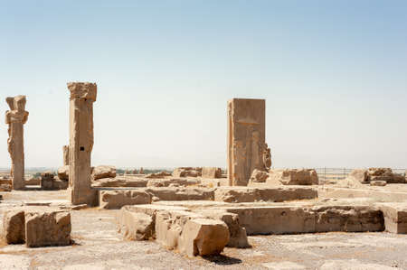 Fabulous view of ruins of the Hadish Palace (the Palace of Xerxes) on blue sky background in Persepolis, Iran. Ancient Persian city. Persepolis is a popular tourist destination of the Middle East.のeditorial素材