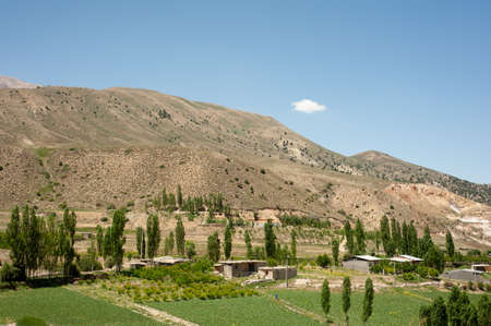 Mountains with garden and village houses and a cloudy sky in mazandaran province, Iran