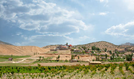Mountains with garden and village houses and a cloudy sky in mazandaran province, Iranの写真素材