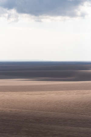 view from Nature and landscapes of dasht e lut or sahara desert after the rain with wet sand dunes and cloudy sky. Middle East desertの写真素材