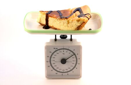 On diet, weighing a piece of cheese cakeの写真素材