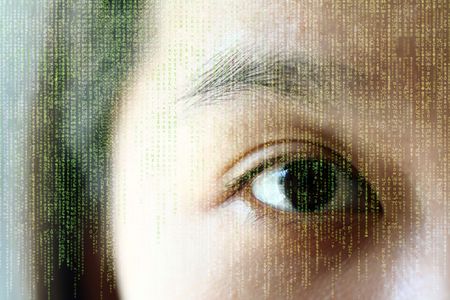 A woman's eye, showing reflection of random lettersの写真素材