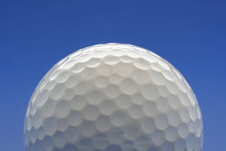 Golf ball on blue backgroundの写真素材