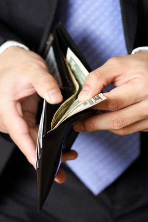 Businessman taking money out of his walletの写真素材