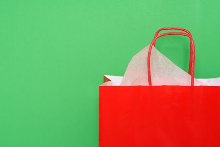 Red shopping bag on green backgroundの写真素材