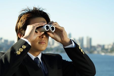 Businessman with binoculars, can be used for business vision/prospect metaphorの写真素材