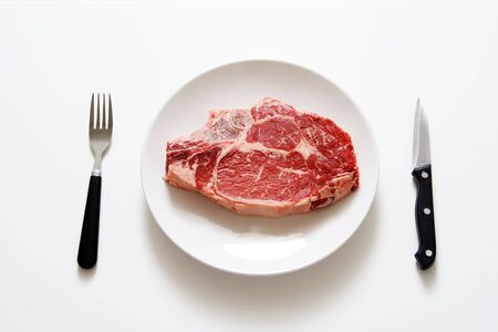 Raw steak on a plateの写真素材