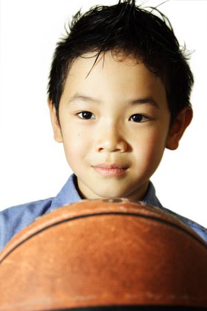A portrait of a young boy with a basketballの写真素材