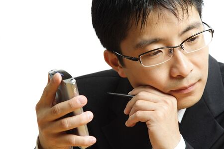 A shot of a businessman working on his PDAの写真素材