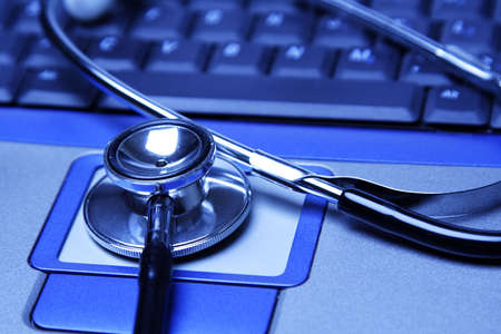 A stethoscope and a laptop in a blue toneの写真素材
