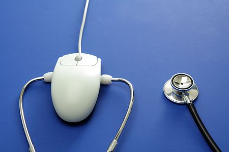 A stethoscope and a mouse in a blue backgroundの写真素材