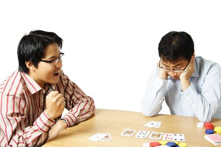 An isolated shot of two young men playing pokerのeditorial素材
