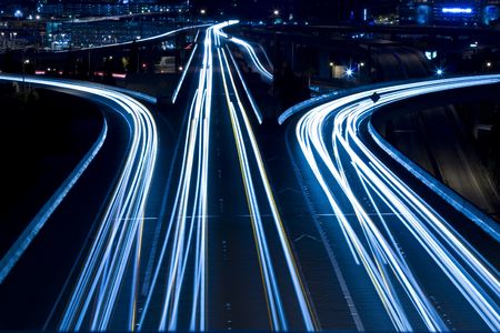 A shot of rush hour traffic on a bridge in blue toneの写真素材