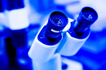 A shot of a microscope in a blue tone (shallow depth of field)の写真素材