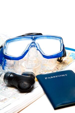 A shot of a passport, a snorkel equipment and a map, can be used for travel or vacation conceptの写真素材