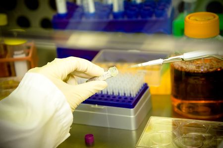 A scientist doing a research and working at the lab in a sterile environment