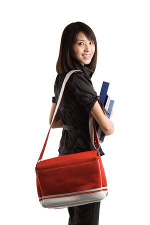 An isolated shot of a beautiful young student carrying booksの写真素材