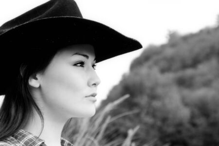 A portrait of a beautiful young woman outdoor in black and whiteの写真素材