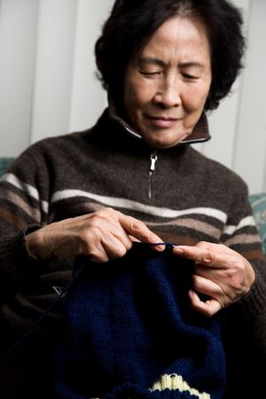 A shot of a senior asian woman knittingの写真素材