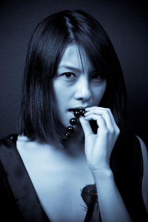 A beautiful asian woman shot in blue toneの写真素材