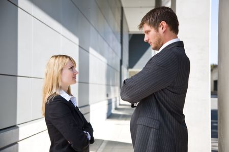 Two caucasian business people looking at each other angrily の写真素材