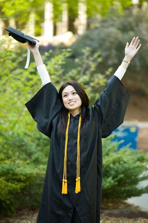 A happy beautiful graduation girl holding the graduation cap