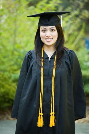 A shot of a happy beautiful graduation girlの写真素材