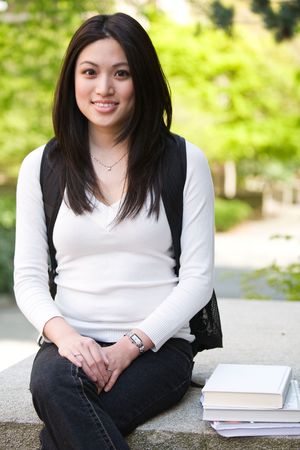 A shot of a beautiful asian college student on campusの写真素材