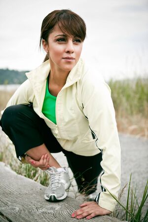 A beautiful asian woman exercises in a parkの写真素材