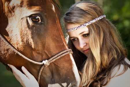 A portrait of a caucasian girl with her horseの写真素材