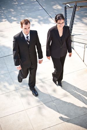A shot of two business people walking together