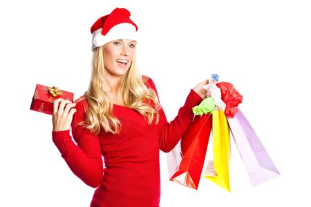 A portrait of a beautiful caucasian christmas santa girl carrying shopping bagsの写真素材