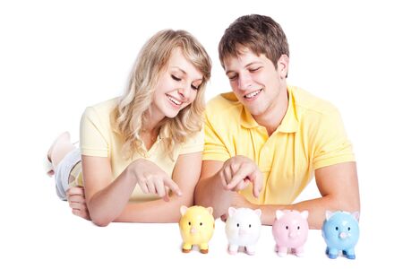 A young couple with piggy banks, can be used for finance or saving conceptの写真素材