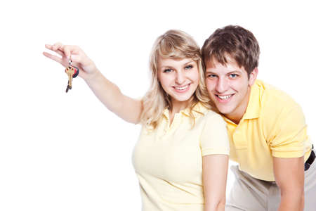 An isolated shot of a young caucasian couple holding a set of keysの写真素材
