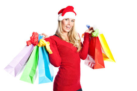 A portrait of a beautiful caucasian christmas santa girl carrying shopping bagsの写真素材