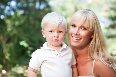 A portrait of a happy caucasian mother with her son outdoorの写真素材