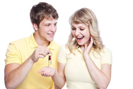 An isolated shot of a young caucasian couple holding a set of keysの写真素材