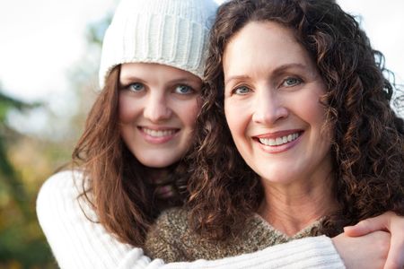 A portrait of a happy mother and daughter outdoorの写真素材