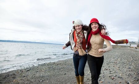 A portrait of two sisters on the beachの写真素材