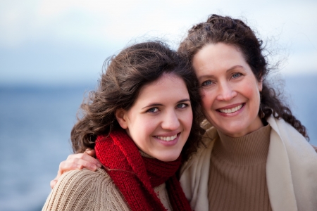 A portrait of a mother and her daughter on the beachの写真素材
