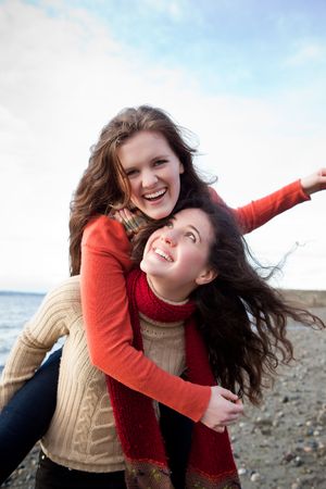 A portrait of two sisters on the beachの写真素材