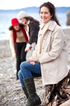A portrait of a mother and her daughters on the beachの写真素材