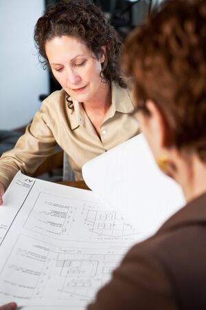 A shot of two businesswomen working in the office
