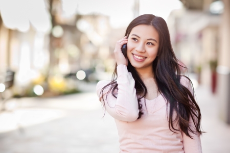 A shot of an asian woman talking on the phoneの写真素材