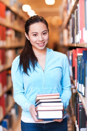 A portrait of an Asian college student studying in the libraryの写真素材