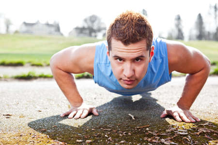 A shot of a mixed race man doing push up outdoor