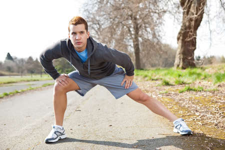 A shot of a mixed race man stretching outdoorの写真素材